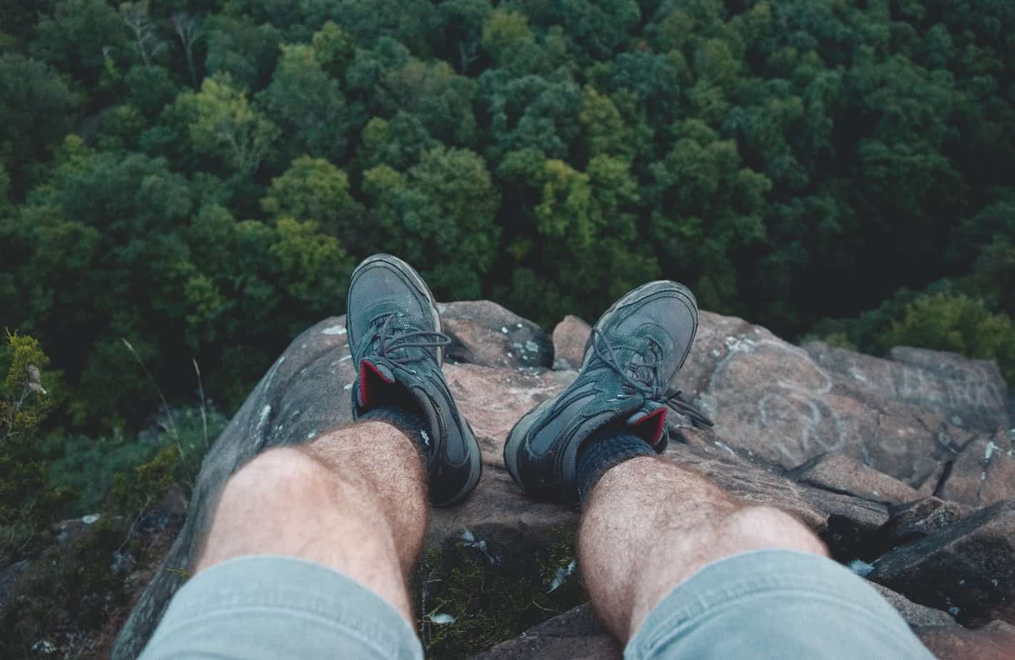 Get To Know The RESILIENT Blue Merle Australian Shepherd 8 Man Standing on Edge of Mountain