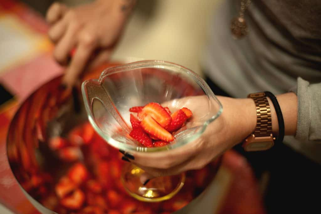 Can Hilarious Pugs Eat Strawberries? 3 Person Holding a Glass With Slice Strawberries