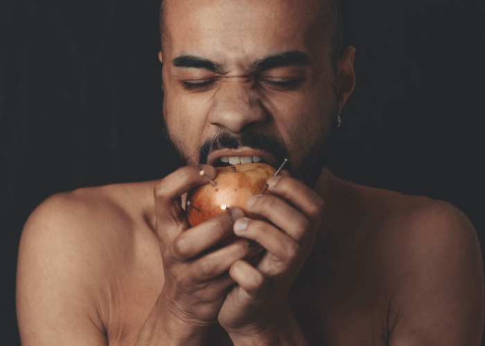 man biting an apple